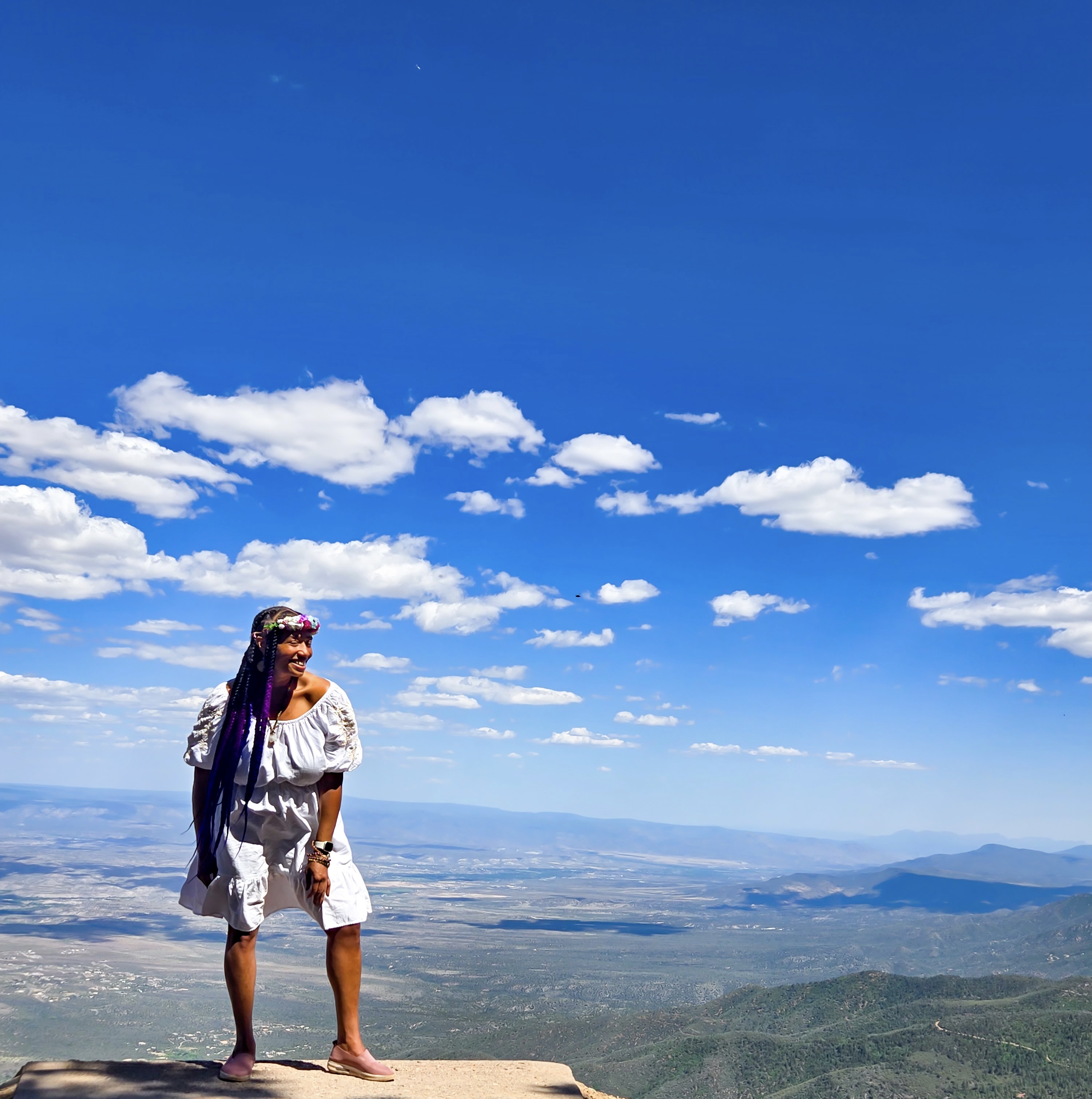 TerDawn DeBoe standing on a mountain top, free and at peace